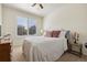 Cozy bedroom has a plush bed, dresser, and bright window with shutter blinds at 12189 Windy Trail Ln, Parker, CO 80138