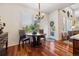 Cozy breakfast nook has a round wood table, decorative chandelier, and sliding glass door at 12189 Windy Trail Ln, Parker, CO 80138