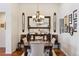 Elegant dining room with a decorative chandelier, large mirror, and traditional decor at 12189 Windy Trail Ln, Parker, CO 80138