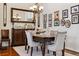 Formal dining room offers wood floors, traditional furniture, and decorative chandelier at 12189 Windy Trail Ln, Parker, CO 80138