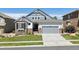 Charming two-story home featuring stone accents, a well-manicured lawn, and an attached two-car garage at 12189 Windy Trail Ln, Parker, CO 80138
