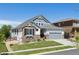 Beautiful home with stone and siding exterior, two-car garage, and landscaped front yard at 12189 Windy Trail Ln, Parker, CO 80138