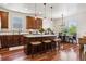 Charming kitchen features a granite island with seating, pendant lights, and stainless steel appliances at 12189 Windy Trail Ln, Parker, CO 80138