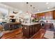 Gourmet kitchen with a large island, stainless steel appliances, and hardwood floors, open to living room at 12189 Windy Trail Ln, Parker, CO 80138