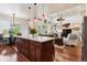 Spacious kitchen with island, stainless steel appliances, and open layout to dining and living areas at 12189 Windy Trail Ln, Parker, CO 80138