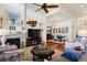 Open-concept living space featuring a fireplace, hardwood floors, and a view into the dining area at 12189 Windy Trail Ln, Parker, CO 80138