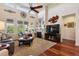 Inviting living room with high ceilings, a stone fireplace, large windows, and hardwood flooring at 12189 Windy Trail Ln, Parker, CO 80138
