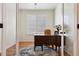 Bright office features a wooden desk, hardwood floors, and natural light from the window at 12189 Windy Trail Ln, Parker, CO 80138