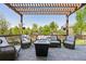 Inviting outdoor living space with comfortable seating, a pergola, and a cozy fire pit at 12189 Windy Trail Ln, Parker, CO 80138