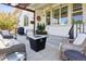 Cozy outdoor patio with wicker furniture, pergola, fire pit, string lights, and a manicured lawn at 12189 Windy Trail Ln, Parker, CO 80138