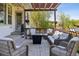 Cozy outdoor patio with wicker furniture, pergola, fire pit, and decorative string lights at 12189 Windy Trail Ln, Parker, CO 80138