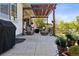 Cozy outdoor patio with wicker furniture, pergola, fire pit, and a manicured lawn at 12189 Windy Trail Ln, Parker, CO 80138