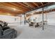 Unfinished basement with carpeting and exposed ceiling features a dining table at 20201 Royal Troon Dr, Monument, CO 80132