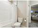 Clean bathroom featuring white subway tile, a shower-tub combination with shower curtain, and white fixtures at 20201 Royal Troon Dr, Monument, CO 80132