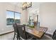 Bright dining room showcasing scenic views, a rustic wooden table, and comfortable seating with modern lighting at 20201 Royal Troon Dr, Monument, CO 80132