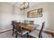 Charming dining room featuring a rustic wooden table, comfortable seating, and a modern light fixture for ambiance at 20201 Royal Troon Dr, Monument, CO 80132