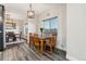 Cozy dining area showcasing a wooden table with seating for six, a decorative light fixture, and scenic outdoor views at 20201 Royal Troon Dr, Monument, CO 80132