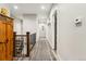 Bright hallway featuring hardwood floors, neutral walls, staircase, and easy access to other parts of the home at 20201 Royal Troon Dr, Monument, CO 80132