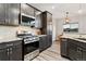 Stylish kitchen featuring stainless steel appliances, granite countertops, subway tile backsplash, and wood-look flooring at 20201 Royal Troon Dr, Monument, CO 80132