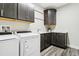 Well-lit laundry room featuring modern washer and dryer, stylish cabinets and sink with plenty of counter space at 20201 Royal Troon Dr, Monument, CO 80132