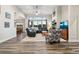 Bright and airy living room with large windows, a cozy fireplace, and stylish hardwood flooring at 20201 Royal Troon Dr, Monument, CO 80132