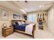 Cozy bedroom featuring carpet floors, a bed with blue covers, and guitar décor for a unique touch at 9625 S Hackberry St, Highlands Ranch, CO 80129