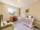 Inviting bedroom with daybed, comfortable seating and a large window offering natural light at 9625 S Hackberry St, Highlands Ranch, CO 80129