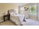 Comfortable bedroom offers a large window, dresser and comfortable queen bed at 9625 S Hackberry St, Highlands Ranch, CO 80129