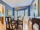 Elegant dining room with a chandelier, bay window, and hardwood floors, perfect for formal gatherings at 9625 S Hackberry St, Highlands Ranch, CO 80129