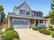 Charming two-story home features a well-manicured front yard and attached two car garage at 9625 S Hackberry St, Highlands Ranch, CO 80129