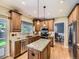 Well-equipped kitchen featuring custom cabinetry, granite countertops, and modern appliances at 9625 S Hackberry St, Highlands Ranch, CO 80129