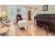 Bright living room boasts hardwood floors, piano, natural light, and relaxing seating at 9625 S Hackberry St, Highlands Ranch, CO 80129