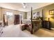 Spacious main bedroom features a canopy bed, neutral carpet, dresser, and a large window with natural light at 9625 S Hackberry St, Highlands Ranch, CO 80129