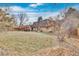 Large backyard featuring a grassy lawn and mature trees, creating a serene outdoor space at 2496 S Leyden St, Denver, CO 80222