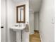 Bathroom with modern pedestal sink and standing shower with glass door at 2496 S Leyden St, Denver, CO 80222