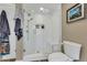 Bathroom featuring glass-enclosed shower with built-in bench and white tile at 2496 S Leyden St, Denver, CO 80222