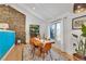 Bright dining room featuring wood floors, stone accent wall, and stylish decor at 2496 S Leyden St, Denver, CO 80222