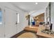 Bright entryway featuring a white door, stone wall accent, and hardwood floors at 2496 S Leyden St, Denver, CO 80222