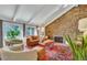 Cozy living room with stone fireplace, vaulted ceilings, and leather sofa at 2496 S Leyden St, Denver, CO 80222