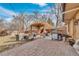 Brick paved patio area with an outdoor kitchen, seating, and shade for outdoor dining and relaxation at 2496 S Leyden St, Denver, CO 80222