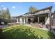 Gorgeous backyard features a pool, patio with comfortable seating, and a built-in grill at 455 Forest St, Denver, CO 80220