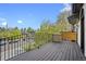 Balcony with dark brown wooden floor and wrought iron railing featuring views of the neighborhood at 455 Forest St, Denver, CO 80220