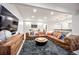 Finished basement living room with large sectional, television, and entertaining area at 455 Forest St, Denver, CO 80220