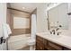 Well-lit bathroom boasts a tub-shower combination, vanity with dark wood cabinets and a decorative mirror at 455 Forest St, Denver, CO 80220