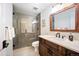 Modern bathroom features a glass-enclosed shower, wood vanity, and sleek fixtures at 455 Forest St, Denver, CO 80220