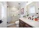 Modern bathroom features a glass-enclosed shower, floating vanity with dark wood cabinets and light countertop at 455 Forest St, Denver, CO 80220