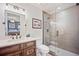 Contemporary bathroom featuring stylish vanity with dark wood cabinets, a toilet, and tiled glass shower at 455 Forest St, Denver, CO 80220