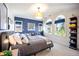 Bright bedroom featuring a blue accent wall, ample natural light, and decorative shelving with sports memorabilia at 455 Forest St, Denver, CO 80220