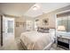 Well-lit bedroom with carpet, neutral paint, and a view of the bathroom and closet at 455 Forest St, Denver, CO 80220