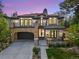 Elegant home with a stone archway garage, charming balconies, and manicured lawn at 455 Forest St, Denver, CO 80220